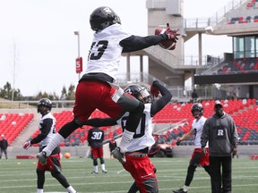Khalil Paden (in the air) and Chris Williams of the Redblacks go through catching drills during a mini camp at TD Place in Ottawa on April 25, 2016. (Jean Levac/Postmedia)