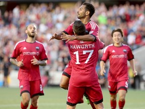 Ottawa Fury's Carl Haworth hoists Paulo Junior in the air after he scored late in the first half against the Vancouver Whitecaps at TD Place in Ottawa on Wednesday, June 1, 2016. (Julie Oliver/Postmedia)