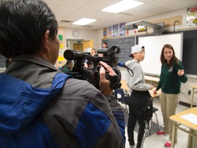 Camera crews follow MTS student Diana Popa and Chinese student Run Qi Li as they enter their French class at Mother Teresa Catholic high school in London, Ont. in April (File photo)