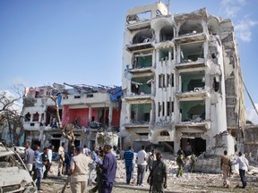 Security forces examine the scene after a bomb attack on Ambassador Hotel in Mogadishu, Somalia, on June 2, 2016. (AP Photo/Farah Abdi Warsameh)