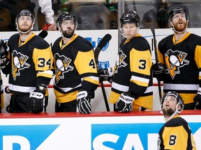 Pittsburgh Penguins’ Tom Kuhnhackl (34), Justin Schultz (4), Olli Maatta (3), Ian Cole (28) and Brian Dumoulin (8) look up at the display board after losing Game 5 of the Eastern Conference final Sunday, May 22, 2016, in Pittsburgh. (AP Photo/Gene J. Puskar)