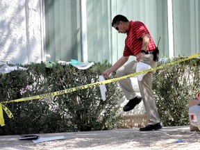 A Phoenix police detective exits  a home, Thursday, June 2, 2016 in Phoenix where three boys were killed during a several hour period Wednesday night.  The boy's mother was hospitalized in critical condition with self-inflicted stab wounds according to Phoenix police. (AP Photo/Matt York)