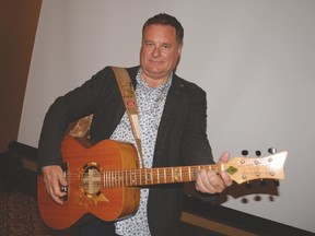 Former CBC radio host Jowi Taylor holds Voyageur, the Six String Nation guitar, during The Town of Stony Plain’s Cultural Summit on May 28. The guitar is made from more than 60 pieces of material representing various aspects of Canadian culture from coast to coast. - Photo by Marcia Love