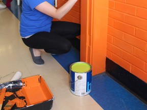 Courtney Rieck from Great Northern Insulation touched up the neon colours at the Fusion Youth Centre in Ingersoll during the United Way's Day of Caring on Thursday, June 2, 2016. (MEGAN STACEY/Sentinel-Review)