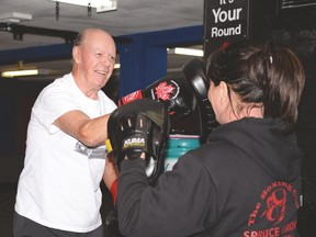 Ken Scott works on his punches with Bobbi Bourbeau, owner of The Boxing Club in Spruce Grove, on May 31. Scott approached the club about developing a boxing program for those with Parkinson’s disease after learning about the benefits it can offer. - Photo by Marcia Love