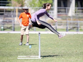 Lo-Ellen  Park Secondary School track coach Colin Ward keeps an eye on hurdler Morgan Smith during practcie for OFSAA at the Laurentian University Community Track in Sudbury, Ont. on Tuesday May 31, 2016. Gino Donato/Sudbury Star/Postmedia Network
