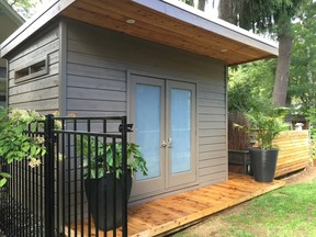 A custom garden shed is given a modern touch and is designed 
to blend in with the rest of the homeowner's yard.