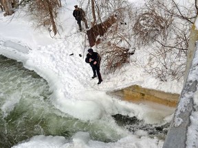 West Grey police officers assist Hanover police near the water's edge by taking a video Monday documenting the spot where Adam Robert Brunt, 30, of Bowmanville, was trapped under ice for approximately 15 minutes during an ice water rescue training exercise in the Saugeen River the previous day before he was pronounced dead several hours later at the Hanover hospital.​ (File photo)