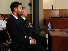 Barcelona's Lionel Messi, foreground, and his father Jorge Horacio Messi sit in court in Barcelona, Spain, on June 2, 2016. (Alberto Estevez/Pool photo via AP)