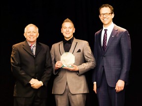 Mason Mehl (centre) accepted the 2015 Top Apprentice Award for the parts technician category in April from the Government of Alberta’s Ministry of Advanced Education. Submitted Photo.