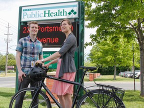 Peter Bearce, public health nurse, left, stands with colleague Rachael Mather, public health dietitian, who rode her bike to work at the KFL&A; Public Health office in Kingston, Ont. on Wednesday June 1, 2016. Bearce is the local coordinator for the 2016 Commuter Challenge taking place across the country from June 5 to June 11. Julia McKay/The Whig-Standard/Postmedia Network