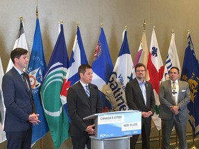 Winnipeg Mayor Brian Bowman (at podium) is joined by Edmonton Mayor Don Iveson (left), Gatineau Mayor Maxime Pedneaud-Jobin and AFN National Chief Perry Bellegarde at the Big City Mayors' Caucus Thursday, June 2, 2016.