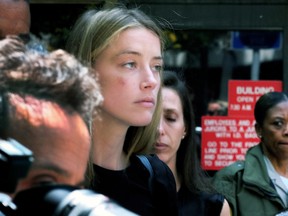 This May 27, 2016 file photo actress Amber Heard leaves Los Angeles Superior Court court, after giving a sworn declaration that her husband Johnny Depp threw her cellphone at her during a fight, striking her cheek and eye. (AP Photo/Richard Vogel,File )