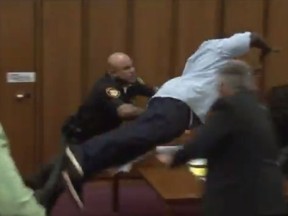 A still image from a video of Van Terry lunging toward convicted sex offender Michael Madison in court. (YouTube/Screengrab)