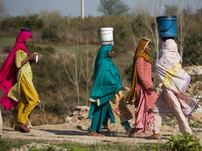 Pakistani women fetch clean water for their families in the suburbs of Islamabad, Pakistan, Tuesday, March 8, 2016. (AP Photo/B.K. Bangash)