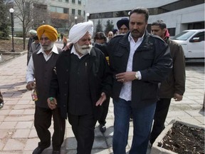 jit Singh father of Jagtar Gill (Centre) is comforted by supporters in this 2014 file photo.(Pat McGrath, Postmedia)