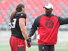 Leroy Blugh (right), defensive line coach of the Ottawa Redblacks, talks to Connor Williams during training camp at TD Place in Ottawa on Thursday, June 2, 2016. (Jean Levac/Postmedia)