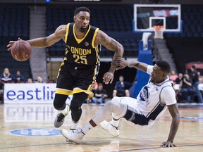 London Lightning's Akeem Wright, left, drives past a falling Halifax Hurricanes' Brandon Bowdry during first half NBL Canada playoff finals action in Halifax on Thursday, June 2, 2016. THE CANADIAN PRESS/Darren Calabrese