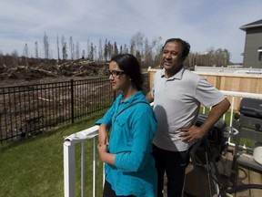 Shafique Khan and daughter Maheen ,11, feel very luck that their Parsons Creek home was saved from the fire that came right up to their backyard. (Greg Southam photo)