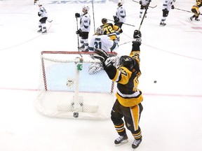 Patric Hornqvist of the Pittsburgh Penguins and Sidney Crosby celebrate after Conor Sheary scored the game-winning goal against the San Jose Sharks to win 2-1 in overtime during Game 2 of the Stanley Cup final at Consol Energy Center in Pittsburgh on June 1, 2016. (Bruce Bennett/Getty Images/AFP)