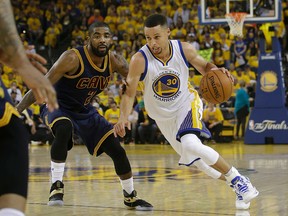 Warriors guard Stephen Curry (right) dribbles against Cavaliers guard Kyrie Irving (left) during the first half of Game 1 of the NBA Finals in Oakland, Calif., on Thursday, June 2, 2016. (Marcio Jose Sanchez/AP Photo)