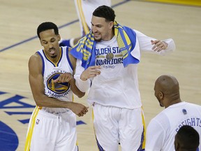 Warriors guard Shaun Livingston (left) and guard Klay Thompson (right) celebrate during the second half of Game 1 of the NBA Finals against the Cavaliers in Oakland, Calif., on Thursday, June 2, 2016. (Marcio Jose Sanchez/AP Photo)