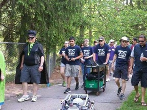 Parkside’s robotics team, led by robot Sir Gamma Ray, walks through Pinafore Park during the Walk For Alzheimer’s on Saturday.
