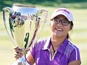 Lydia Ko holds the trophy after winning the 2013 LPGA Canadian Women's Open in Edmonton