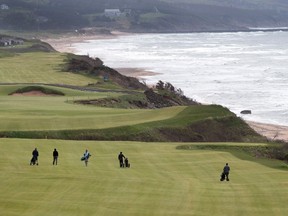 Golfers walk the fairway on the 528 yard, par 5, 18th hole at Cabot Cliffs, the seaside links golf course rated the 19th finest course in the world by Golf Digest, is seen in Inverness, N.S. on Wednesday, June 1, 2016. Located between the coal mining town of Inverness and the Gulf of St. Lawrence, the sister course to Cabot Links is receiving rave reviews and drawing international attention. THE CANADIAN PRESS/Andrew Vaughan