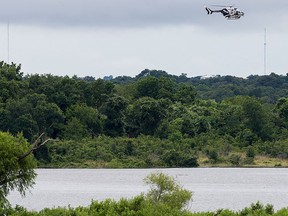 A Texas DPS helicopter flies over Lake Belton near the scene of an accident at Fort Hood at Owl Creek Park near Gatesville, Texas, on Thursday, June 2, 2016.  (Michael Miller/The Temple Daily Telegram via AP)