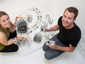 London artists Paulina Szczesny and Matthew Trueman, of London Print, use handmade stamps to apply footprints to a bolt of fabric in a studio in London, Ont. on Friday May 20, 2016. London Print will have around 50 stamps on hand at Nuit Blanche this year, where participants will be able to create animal tracks down Dundas Street as the fabric is unrolled.  (Craig Glover/The London Free Press/Postmedia Network)