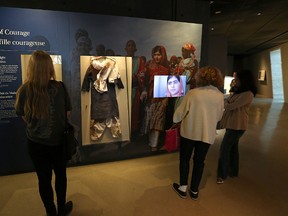 Patrons view the Girl of Courage: Malala's Fight for Education exhibit in the Today's Rights gallery on Level 5 of the Canadian Museum for Human Rights in Winnipeg on Friday. Artifacts include the school uniform Malala Yousafzai was wearing when she was shot in the head by a Taliban gunman  and her 2014 Nobel Peace Prize diploma. The exhibit can be viewed until March 14, 2017. (Kevin King/Winnipeg Sun)