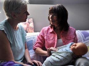 Jill Ritchie, a local doula and childbirth educator (right), demonstrates massage techniques to Fanshawe College professor Jodi Hall at Babeeze Doula Centre in London Ont. June 2, 2016. In September, Fanshawe College will be the first in Ontario to offer a program in doula studies. CHRIS MONTANINI\LONDONER\POSTMEDIA NETWORK