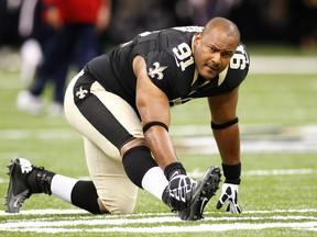 In this Aug. 25, 2012, file photo, New Orleans Saints defensive end Will Smith stretches before a preseason game in New Orleans. (AP Photo/Bill Haber, File)