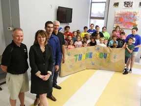Harold Parsons (from left), executive director for the Boys and Girls Club of Kingston, Liza Nelson and Steve Serviss, campaign co-chairs, and Peter Kingston, president of the board of the directors, are joined by children and club staff to say thank you to the community for helping Whig-Standard/Boys and Girls Club Campaign exceed its goal of $100,000. (Elliot Ferguson/The Whig-Standard)