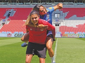 Canada’s women’s soccer team captain Christine Sinclair (left) and Brazil captain Marta get playful following a media session yesterday at BMO Field. (Neil Davidson, The Canadian Press)