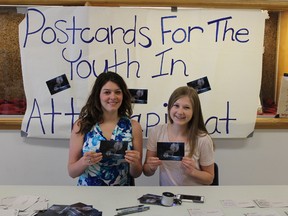 Esme Ariss (left) and Carlie Tuck (right) seen on June 3 in Kingston are collecting messages of hope and encouragement to send to the youth of Attawapiskat at their school. (Jane Willsie/For The Whig-Standard)
