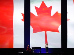 Recording artist Chilly Gonzales and Recording artist Veronic DiCaire perform the Canadian national anthem during the opening ceremony for the 2015 Pan Am Games at Pan Am Ceremonies Venue. Mandatory Credit: Rob Schumacher-USA TODAY Sports