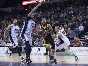 London Lightning's Akeem Scott, second from right, drives past Halifax Hurricanes, from left to right, Justin Johnson, Mike Glover, and Joel Friesen during first half NBL Canada playoff finals action in Halifax on Friday, June 3, 2016. THE CANADIAN PRESS/Darren Calabrese