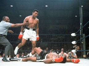 In this May 25, 1965, file photo, heavyweight champion Muhammad Ali is held back by referee Joe Walcott (left) after he knocked out challenger Sonny Liston in the first round of their title fight in Lewiston, Maine. Ali, the magnificent heavyweight champion whose fast fists and irrepressible personality transcended sports and captivated the world, has died according to a statement released by his family Friday, June 3, 2016. (AP Photo/File)