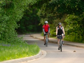 Margot Khan and Brian Howell descend a hill on the multi-use pathway through Springbank Park in London, Ont. on Friday June 3, 2016. 
Mike Hensen/The London Free Press/Postmedia Network