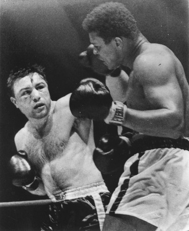George Chuvalo (left) lands a punch to the head of Muhammed Ali during their boxing match in Toronto in 1966. THE CANADIAN PRESS