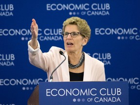 Ontario Premier Kathleen Wynne, centre, speaks to reporters accompanied by Quebec Premier Philippe Couillard and California Governor Jerry Brown at the Climate Summit of the Americas in Toronto on Wednesday, July 8, 2015. (THE CANADIAN PRESS/Darren Calabrese)