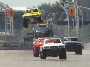 The Stadium Super Trucks hit the jumps on the front straightaway during their race in Toronto in this file photo. (Postmedia Network)