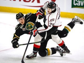 London Knights defencman (left) Olli Juolevi is checked by Rouyn-Noranda Huskies’ Alexandre Fortin at the Memorial Cup. (CP)