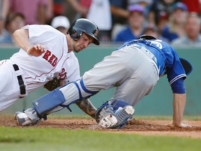 Boston Red Sox's Blake Swihart scores past Toronto Blue Jays' Russell Martin during the sixth inning of a baseball game at Fenway Park in Boston on June 4, 2016. (AP Photo/Michael Dwyer)