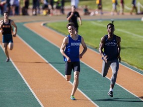 Ryder Horton, in blue, takes first place during the men's 400 metre dash junior event during the 2016 ASAA Track and Field Championships at Foote Field in Edmonton, Alta., on Saturday, June 4, 2016