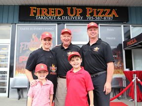 Azilda Fired Up Pizza owner/operator MJ Pappin-Lamoureux, and her kids, Jordan, 5, and Jacob, 7, Randy Carlyle, former NHL coach and player, and Rob Chaput, founder of Fired Up Pizza, were on hand for the grand opening of the Azilda location in Greater Sudbury, Ont. on Friday June 3, 2016. John Lappa/Sudbury Star/Postmedia Network