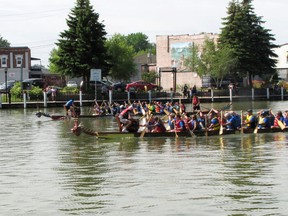 Dragon boat racing teams from across southwestern Ontario descended on the forks of the Sydenham River in downtown Wallaceburg Saturday for the 15th annual Sydenham Challenge Dragon Boat Festival. Above, the RBC Royal Rowers (foreground) take on the Blazing Paddles. The Royal Rowers pulled off a very close win. DON ROBINET/COURIER PRESS/Postmedia Services