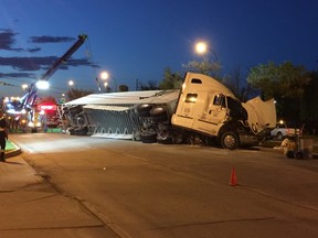 A tractor-trailer unit was spotted lying on its side on Highway 75 Saturday night. (Cody Acott/Winnipeg Sun)